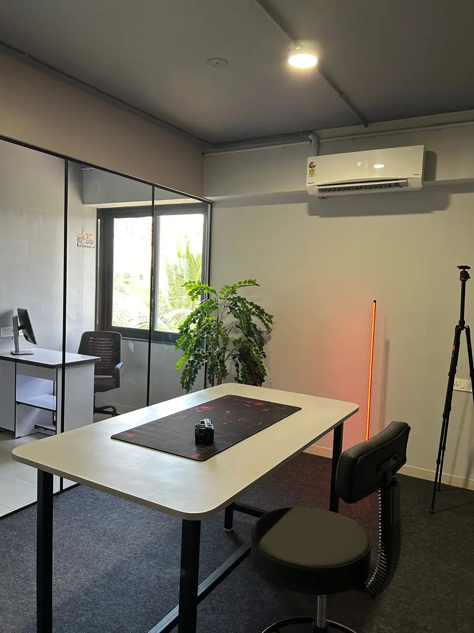 Desk set with a window and a camera tripod