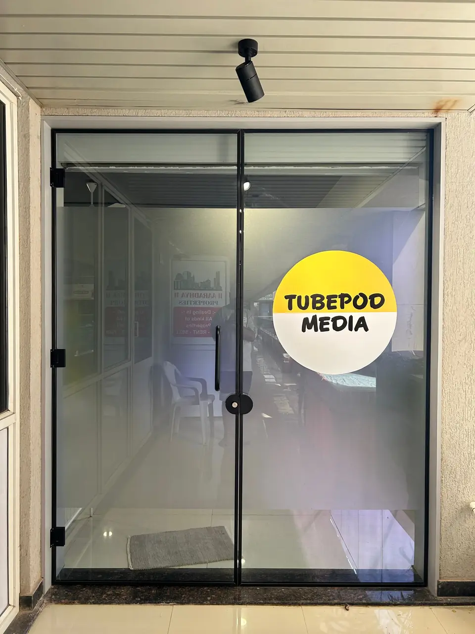 TubePod Media glass entrance door with the yellow logo