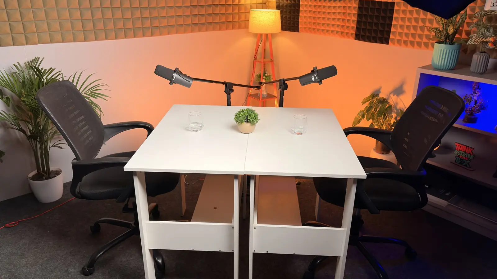 Podcast set with acoustic foam wall, two chairs and two SM7B microphones