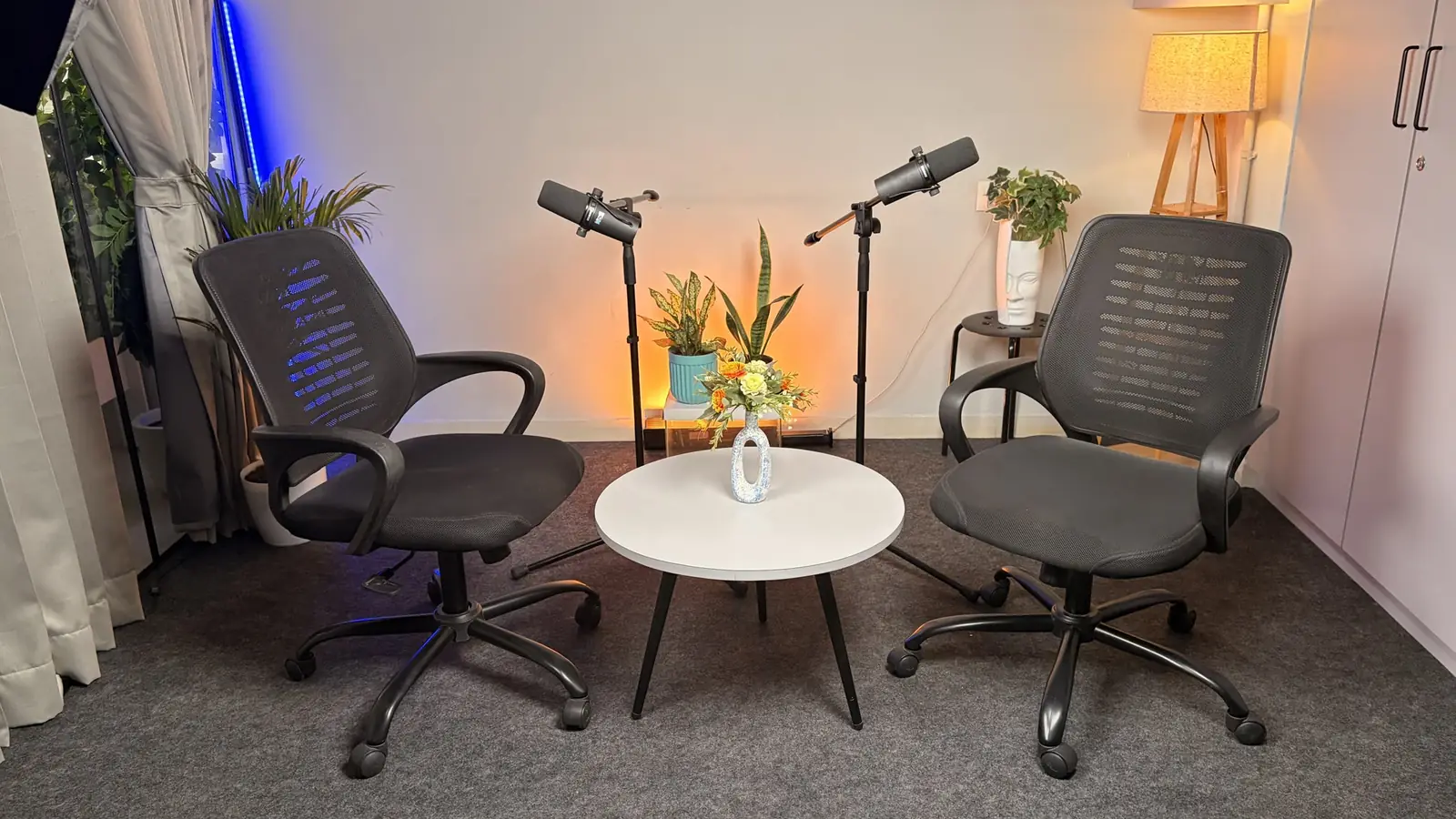 Round-table podcast setup at TubePod Media with two chairs and two microphones
